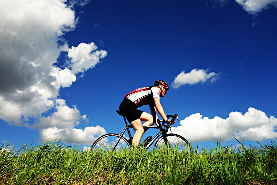 man biking blue skies