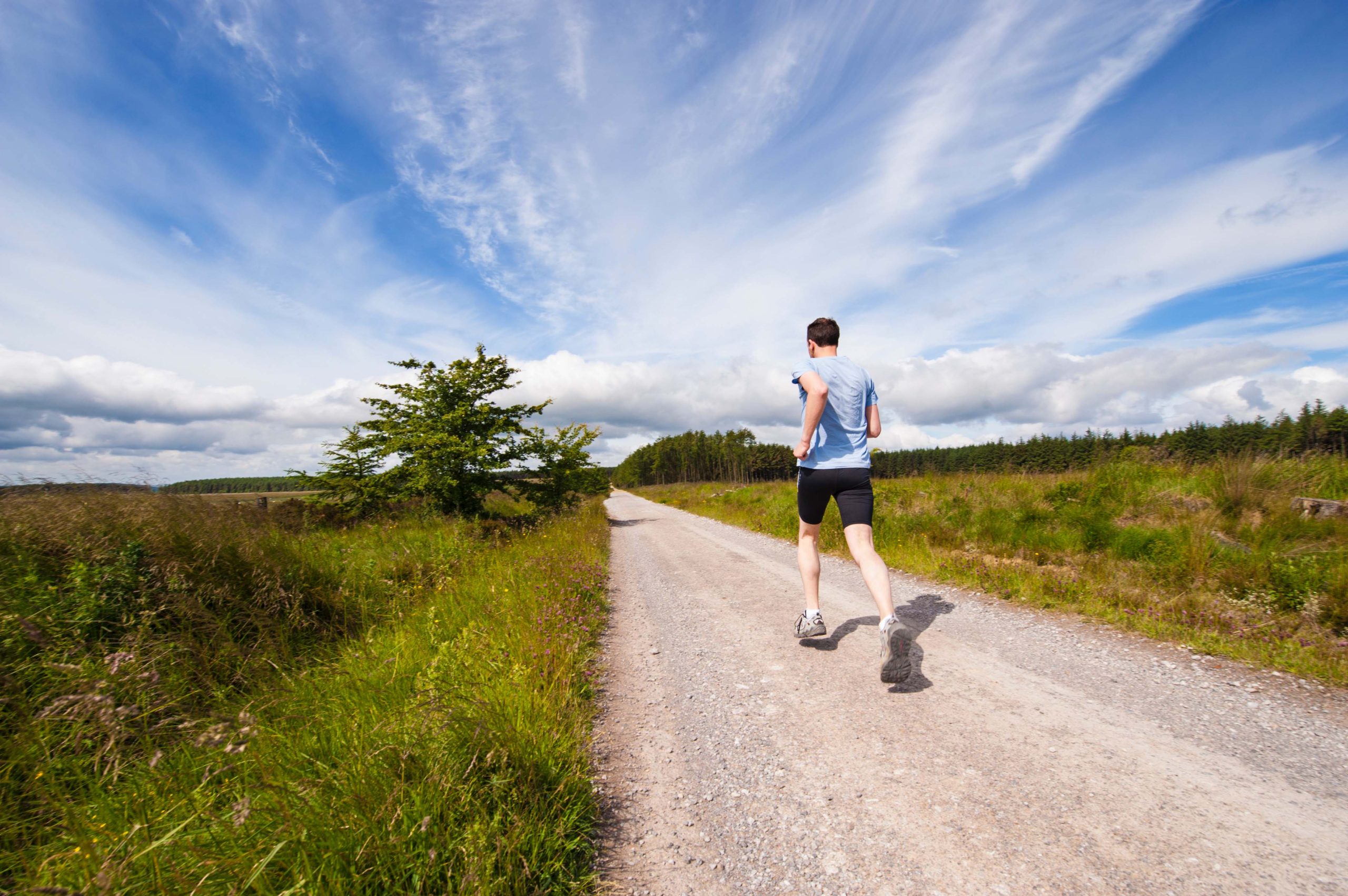 man running_road_blue sky